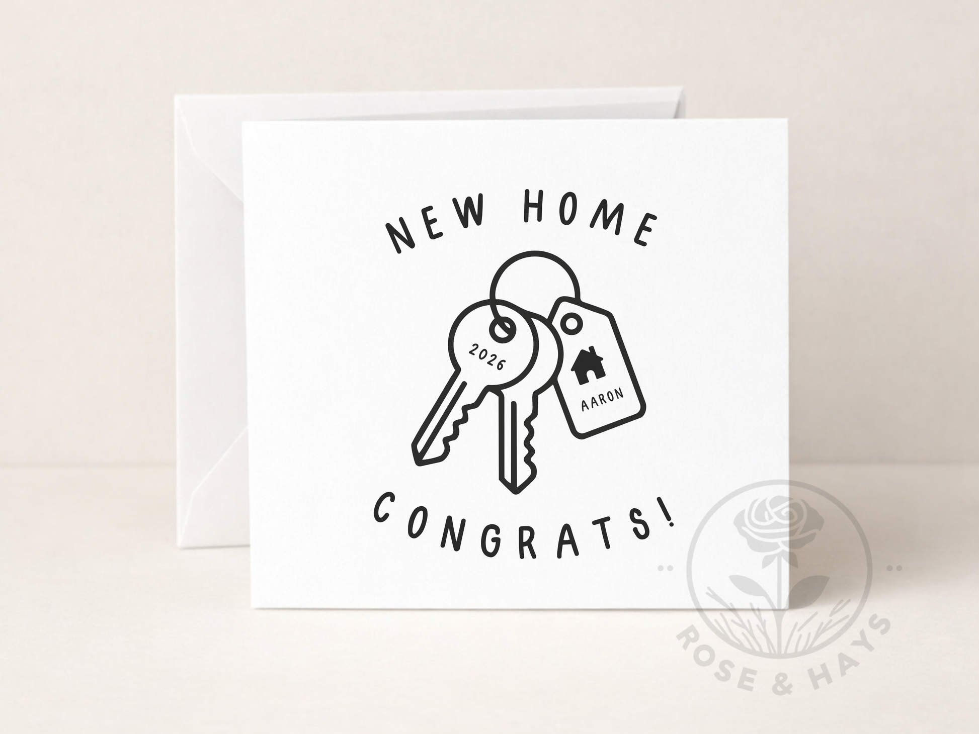 Greeting card with keys and 'New Home Congrats!' text on a beige background