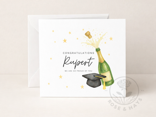 Graduation-themed card with champagne bottle and cap, personalized with 'Congratulations Rupert, we are so proud of you!'